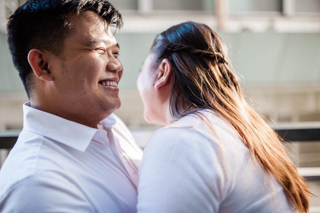 man and woman kissing during sunset