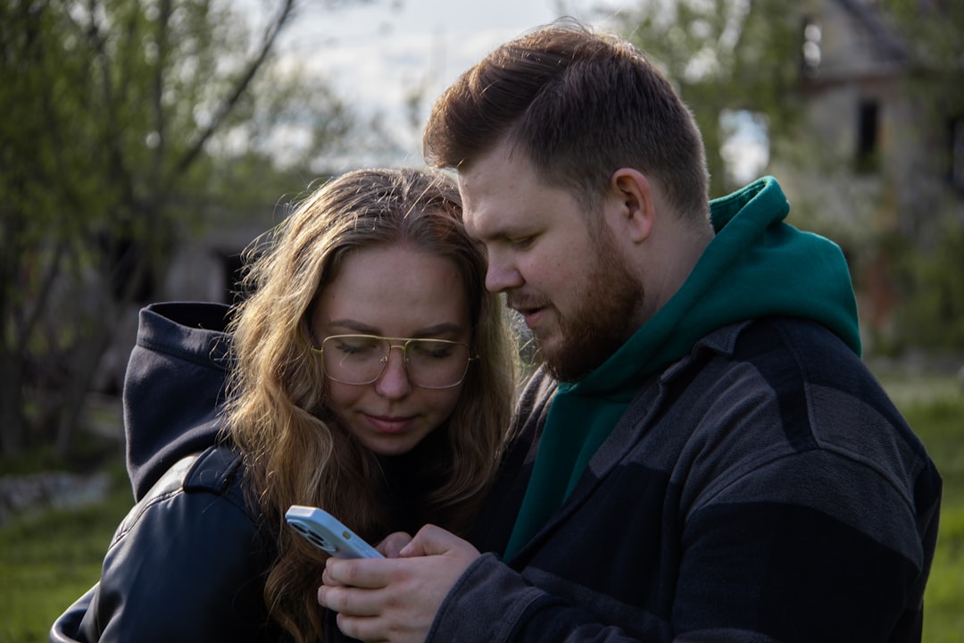 a man and a woman looking at a cell phone
