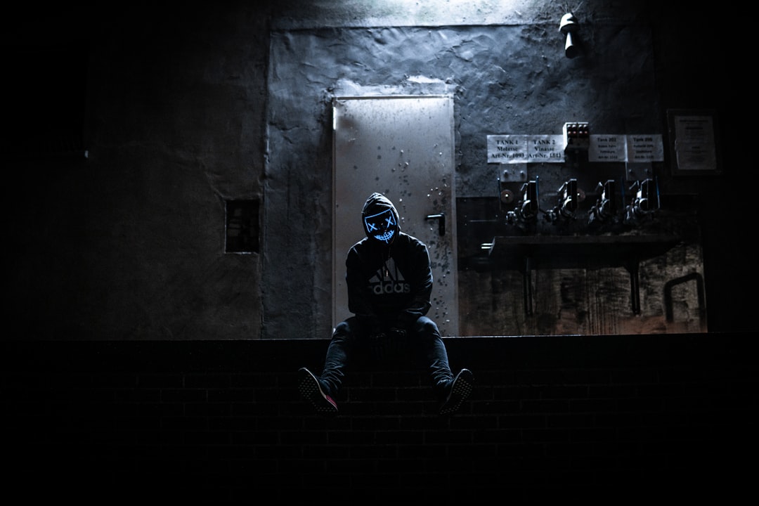 a man wearing a mask in a dark tunnel
