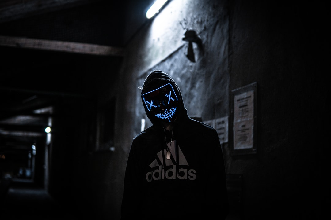 a man wearing a mask in a dark tunnel